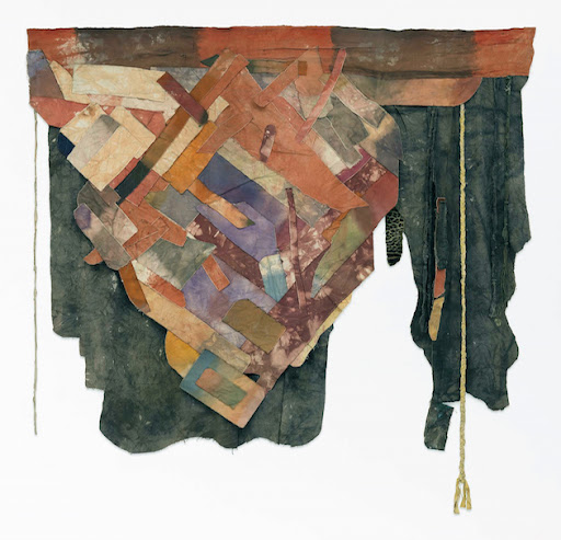 Abstract mixed-media textile artwork featuring layered, woven fabric pieces in earthy tones of rust, ochre, and muted purple. The composition includes frayed edges, hanging rope elements, and a textured backdrop, creating a dynamic and organic aesthetic.